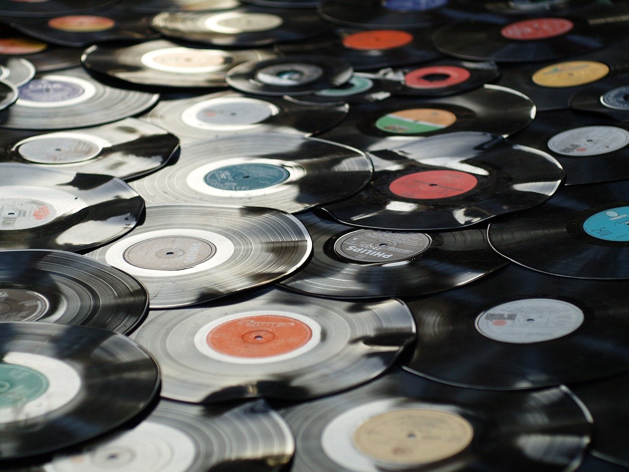 Multiple vinyl record albums piled all together